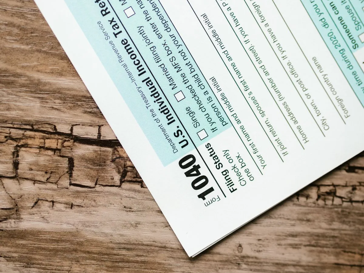 A US Form 1040 individual income tax return lying on a worn wooden table.