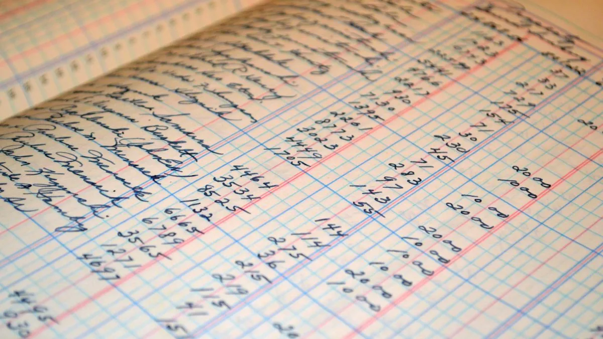 A handwritten columnar ledger, its money columns ruled in red and blue, filled in by hand.
