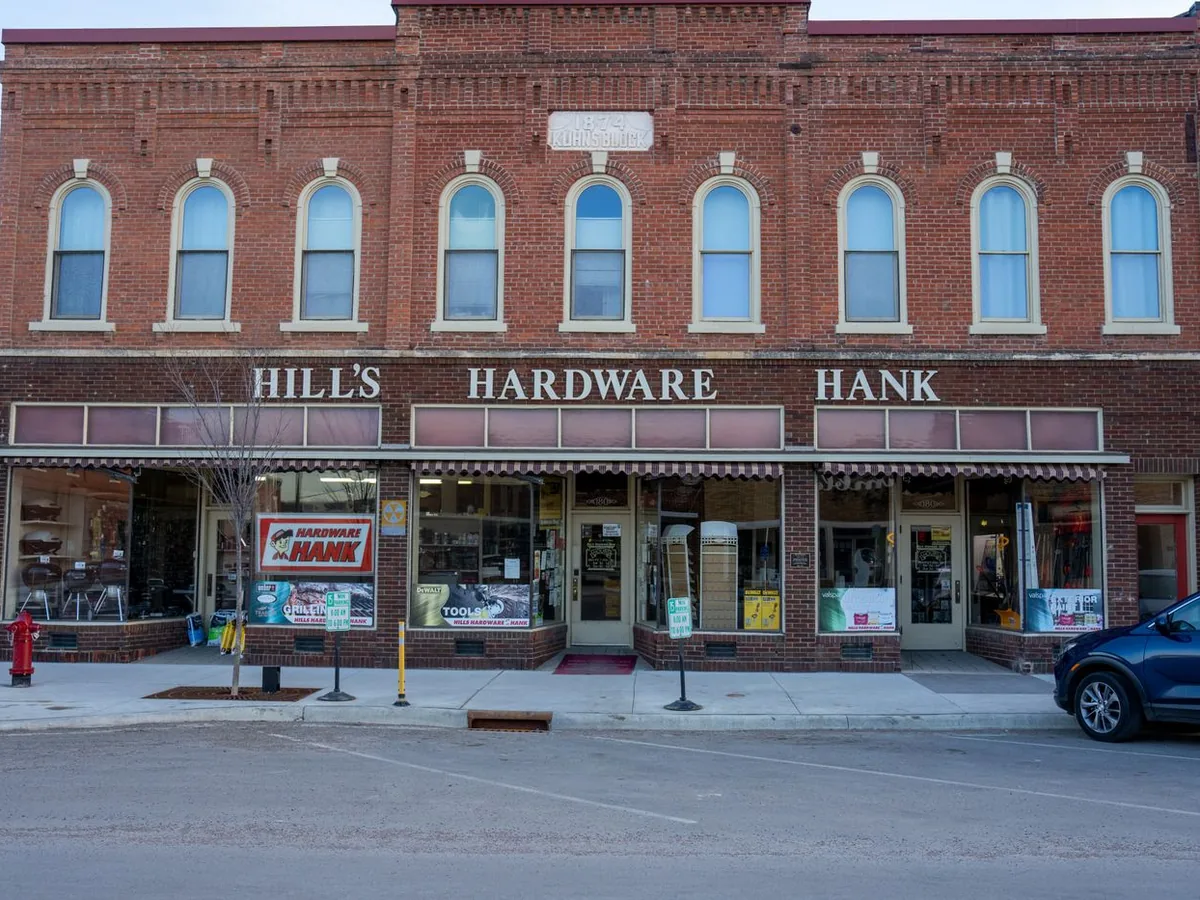 A family hardware store in a two-storey brick building on a small-town main street. Not a client of the practice.